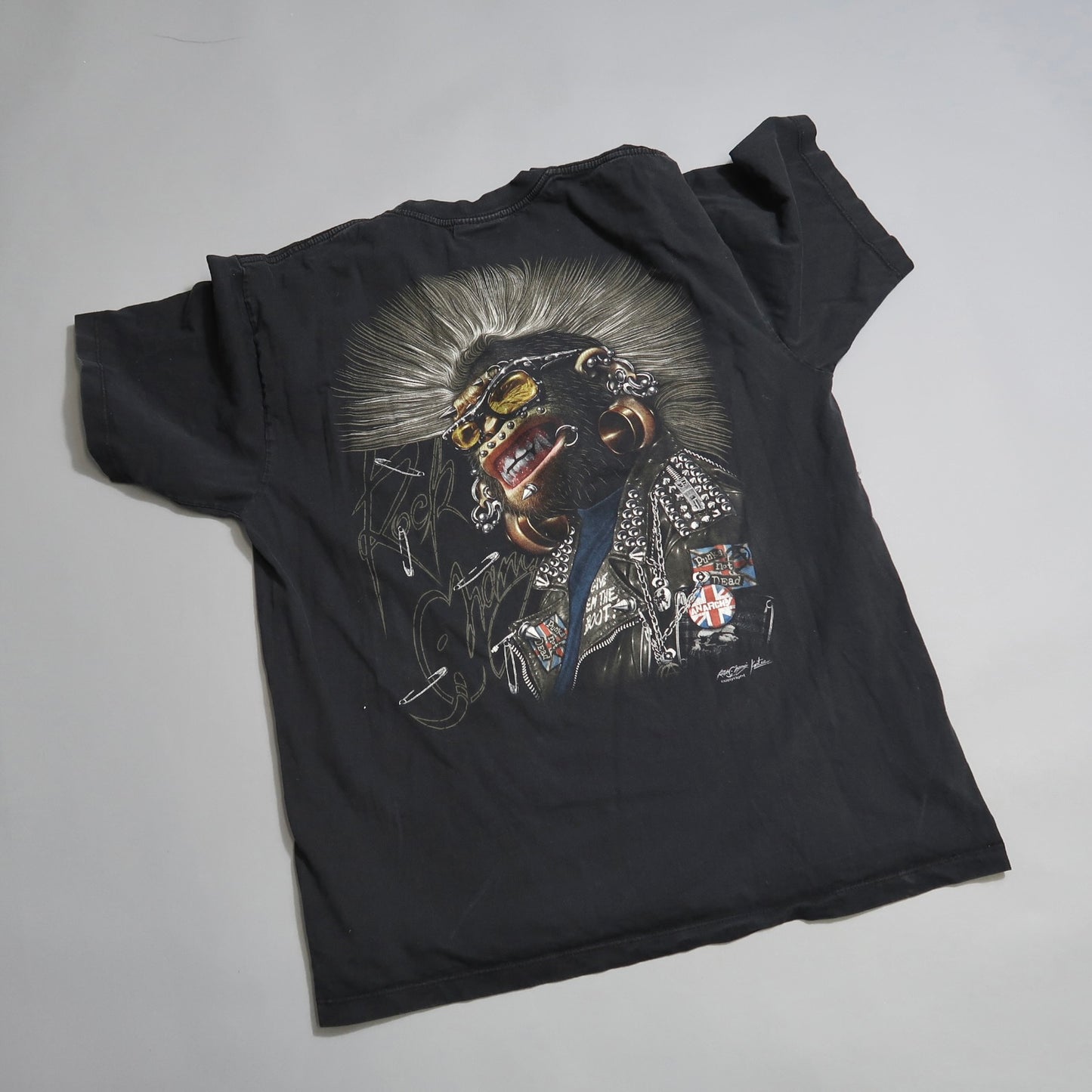 Black T-shirt with punk-style graphic design on the back.