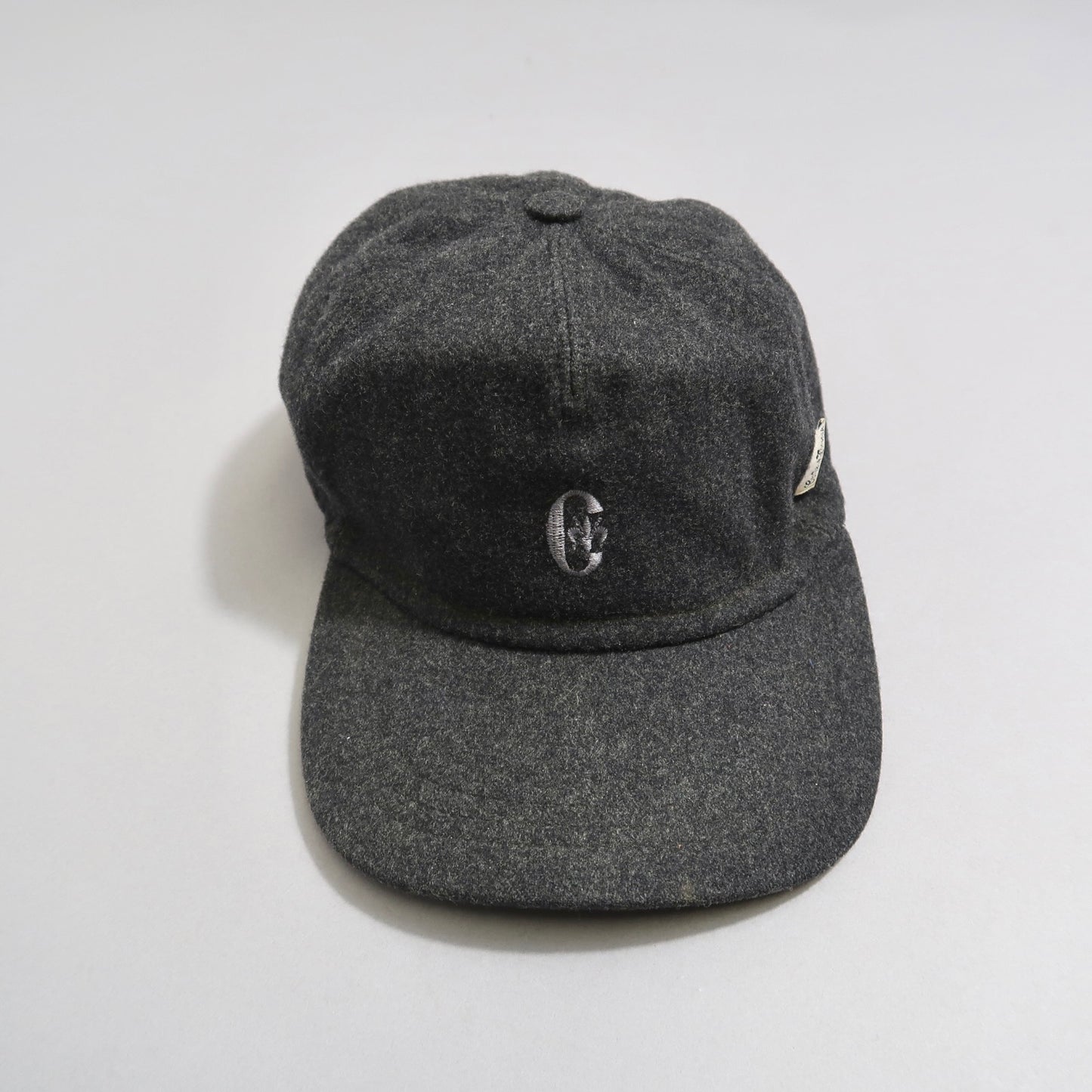 Dark gray baseball cap with a nullCnull logo on the front.