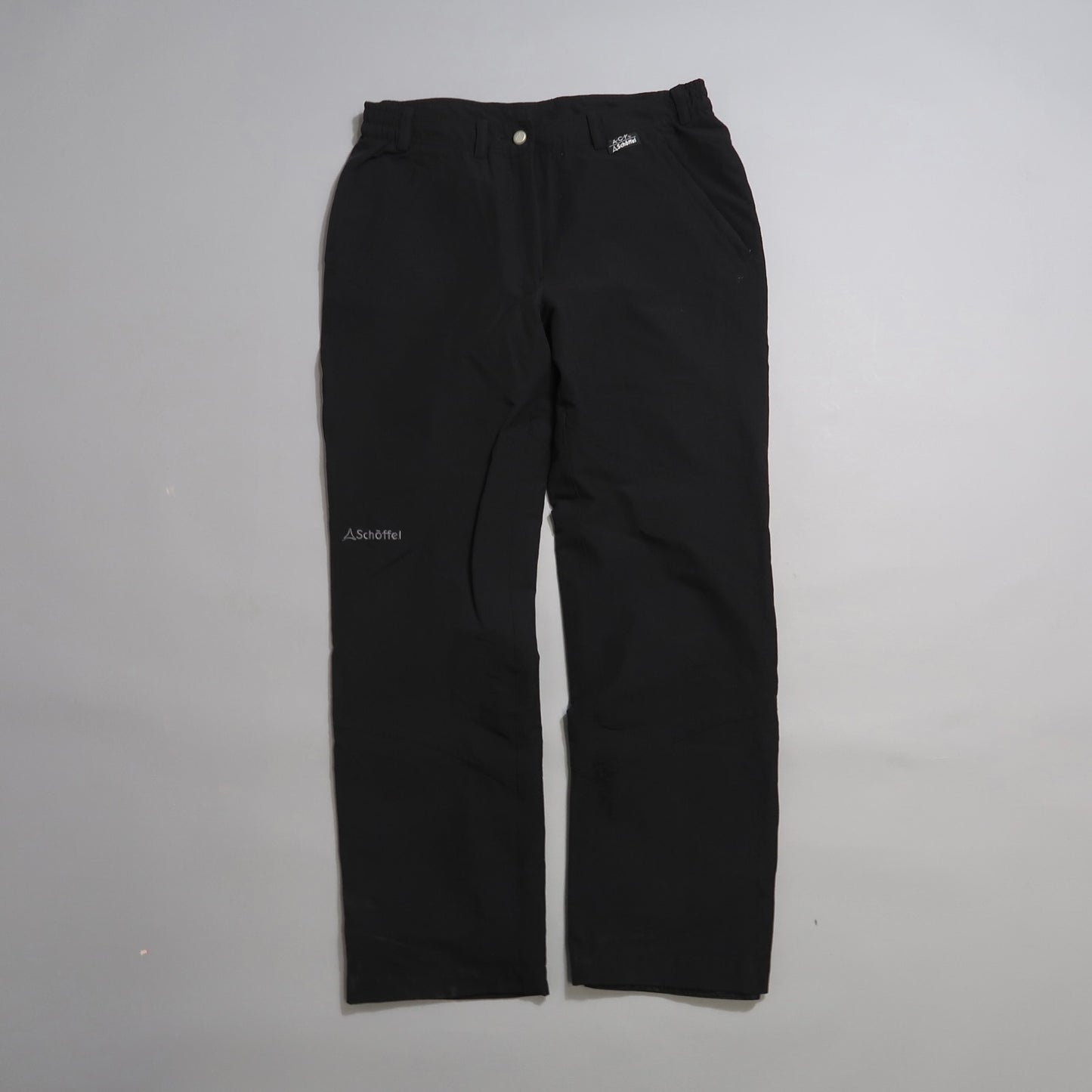 Black Schöffel pants on a plain gray background.