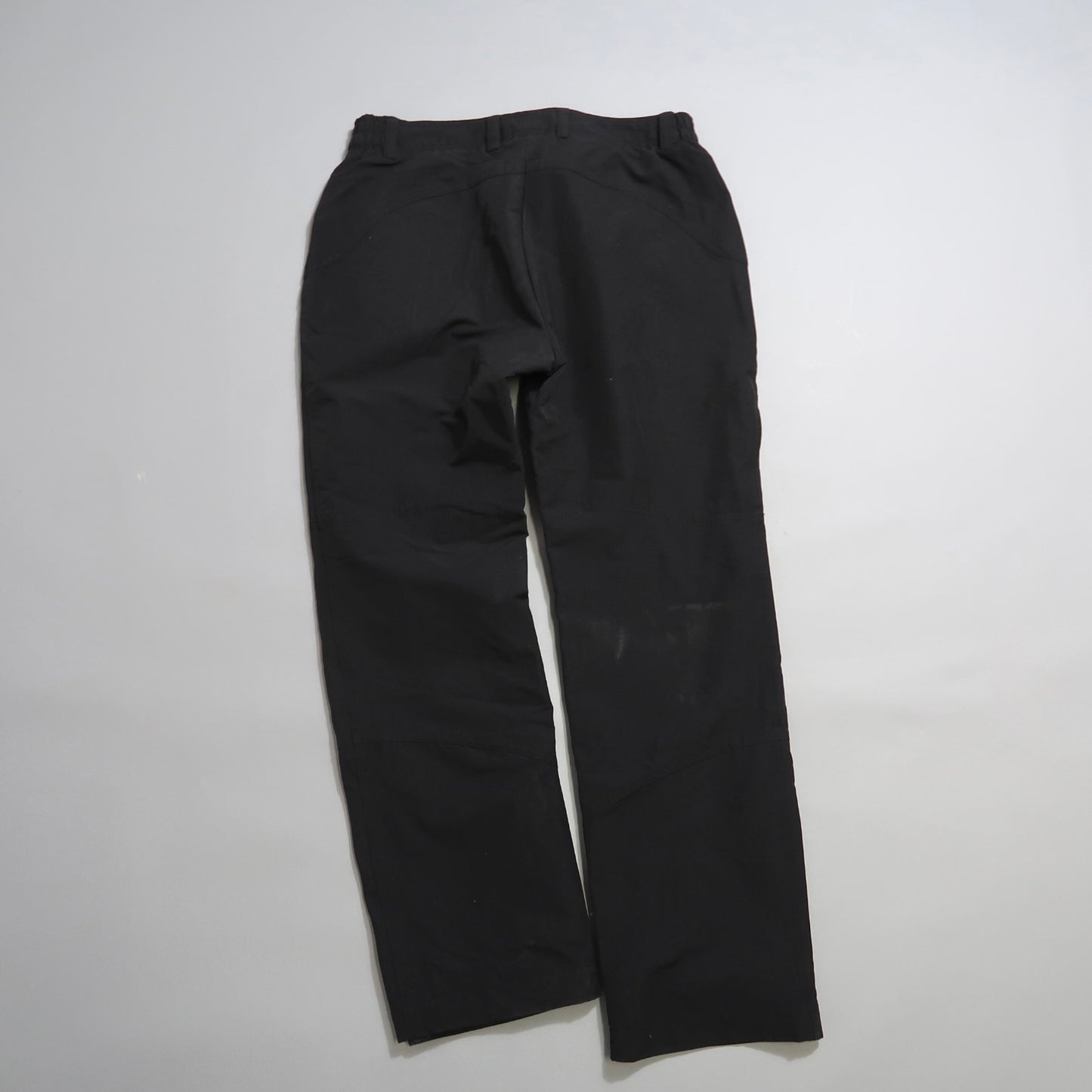 Black pants laid flat on a plain white background.