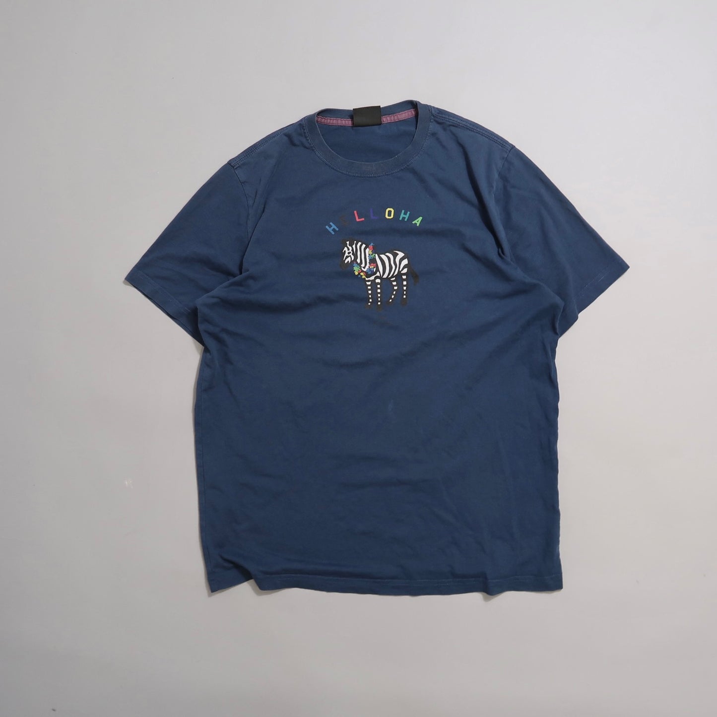 Blue T-shirt with nullALOHAnull and a colorful zebra design.