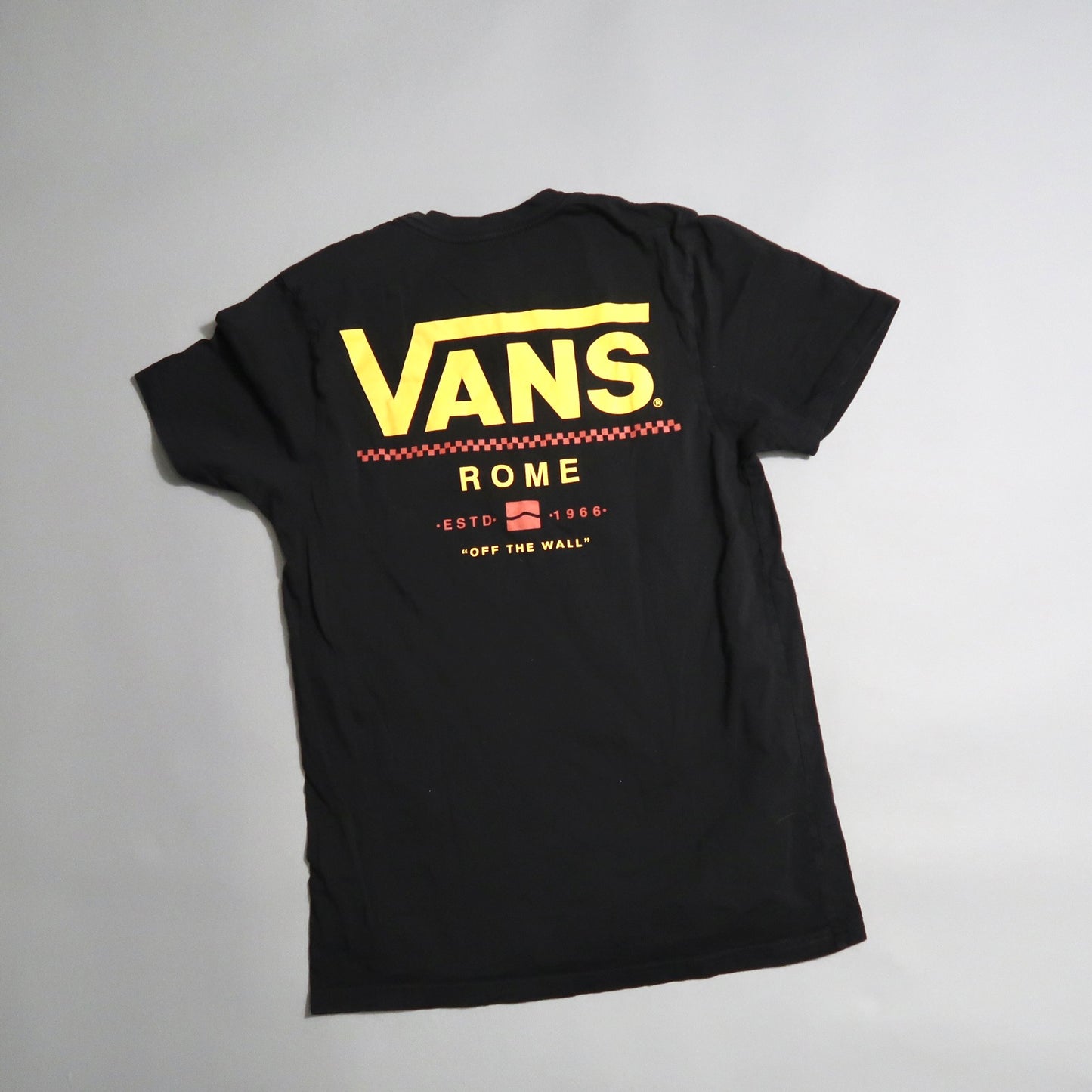 Black Vans T-shirt with yellow logo and nullRomenull text on the back.