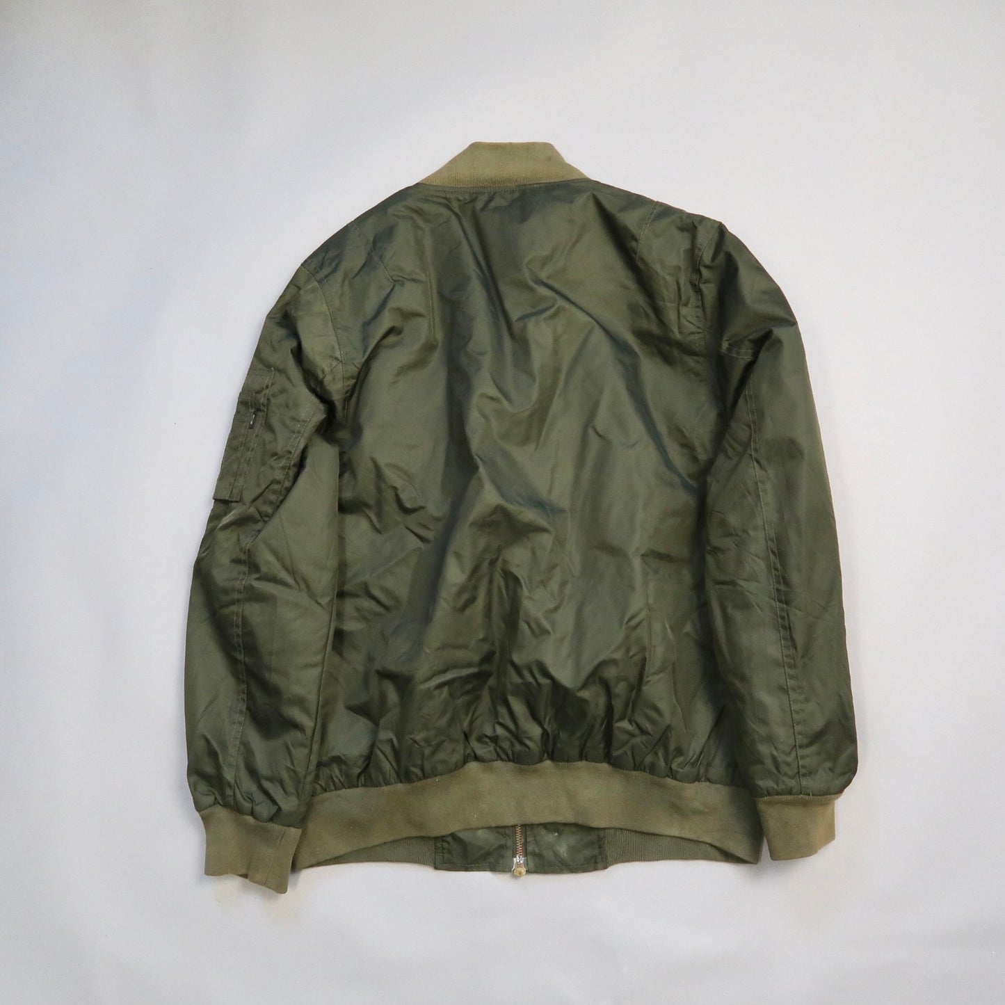 Olive green bomber jacket, back view, on a plain background.