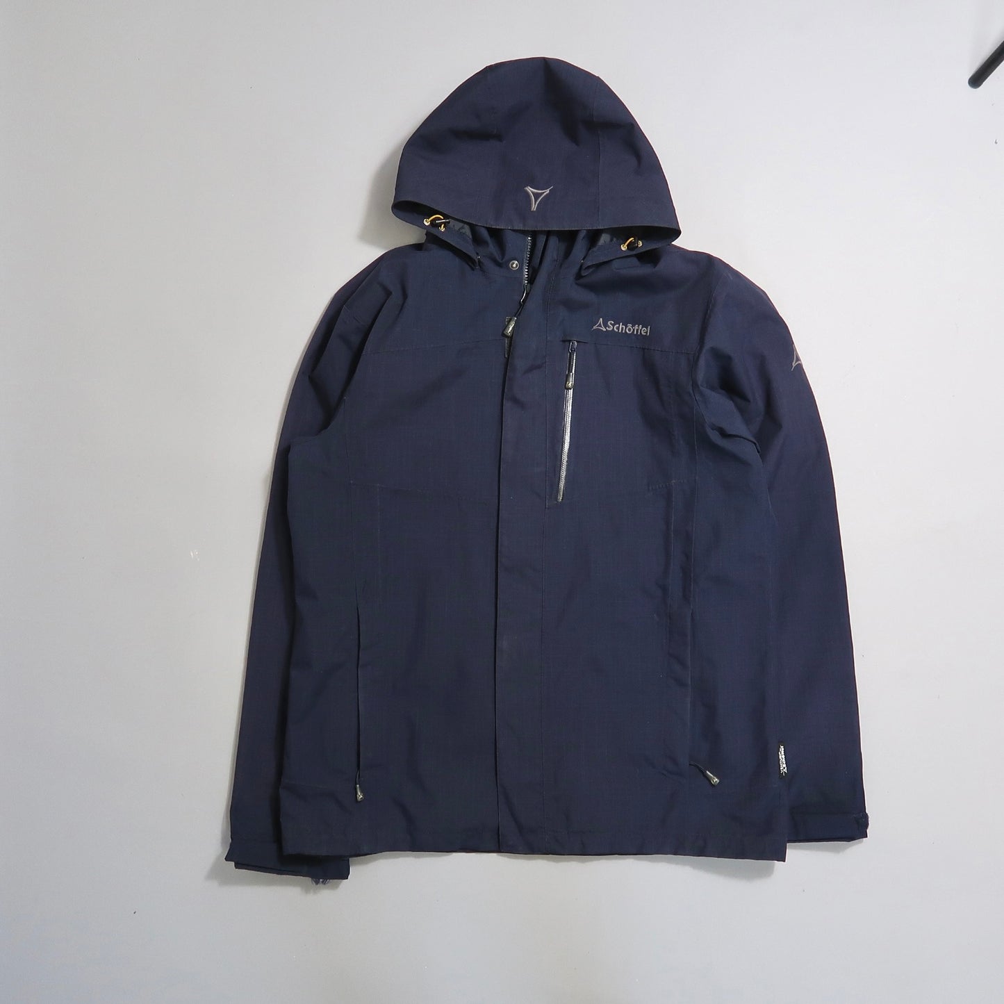 Dark blue hooded jacket with front zipper pocket on white background.