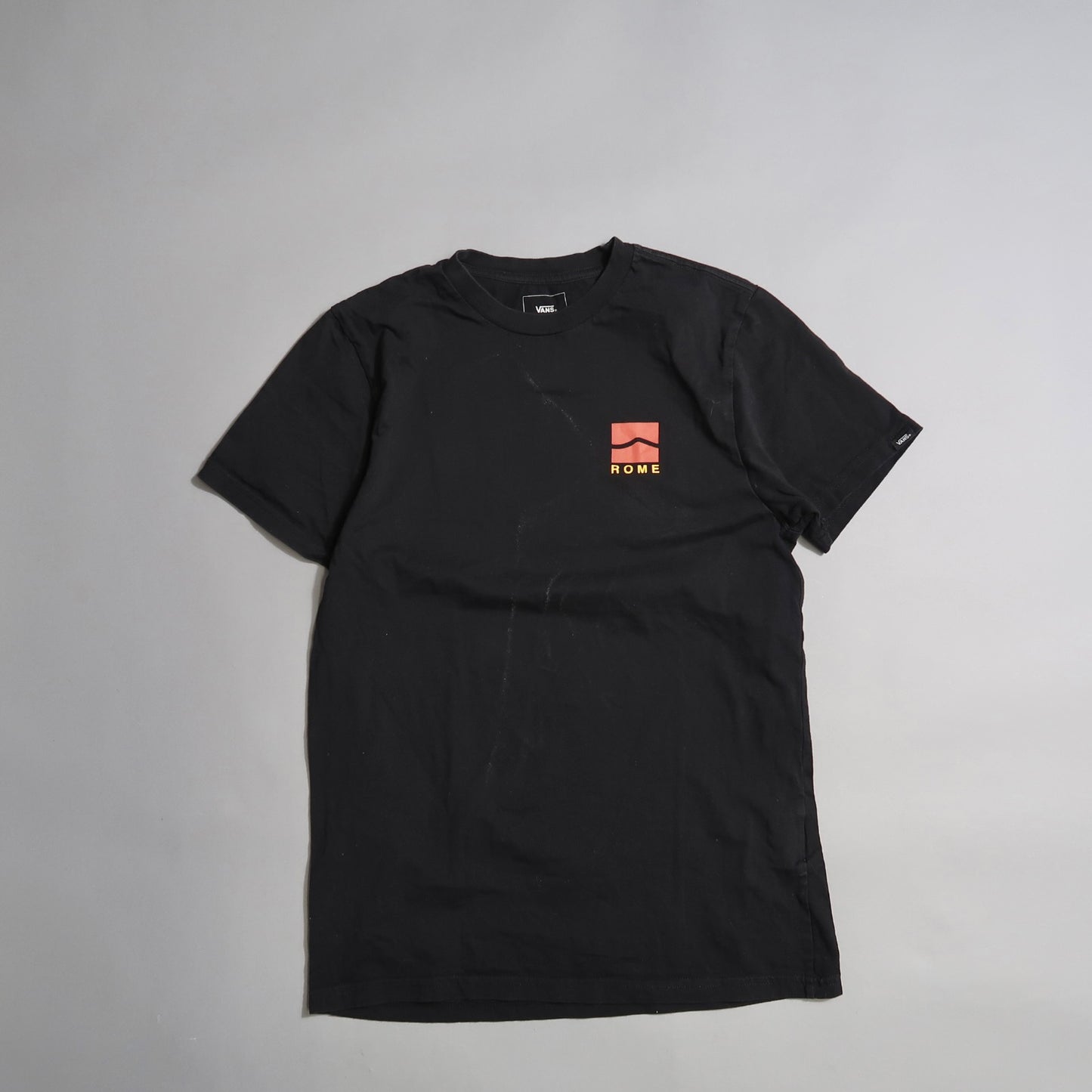 Black T-shirt with a red logo and nullROMEnull text on the front.
