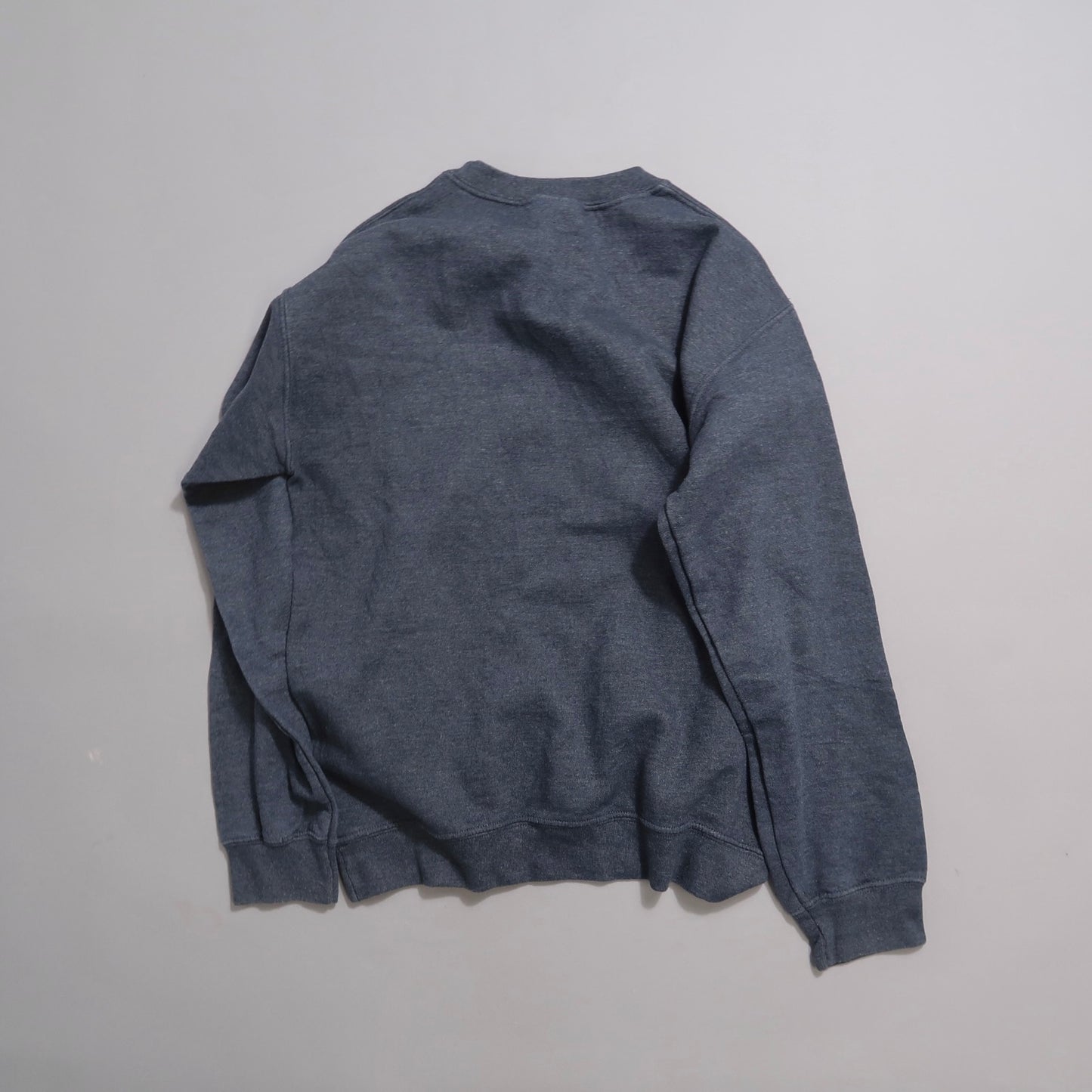 Dark gray sweatshirt on a light background, viewed from the back.