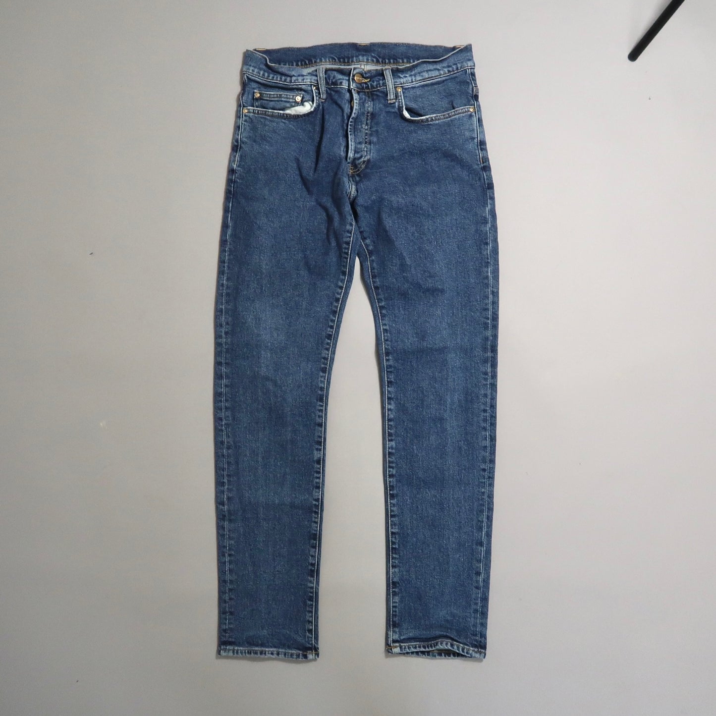 Blue jeans on a light gray background.