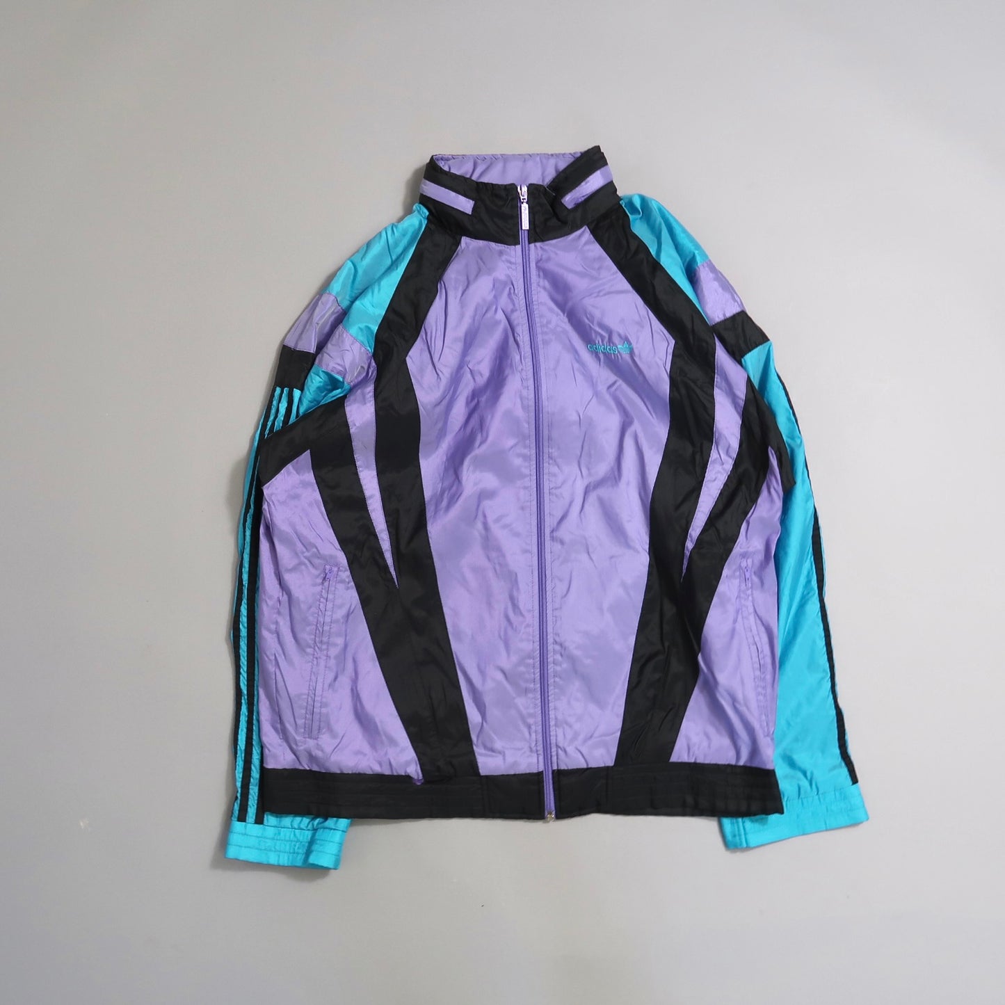 Vintage windbreaker with purple, teal, and black color blocks.