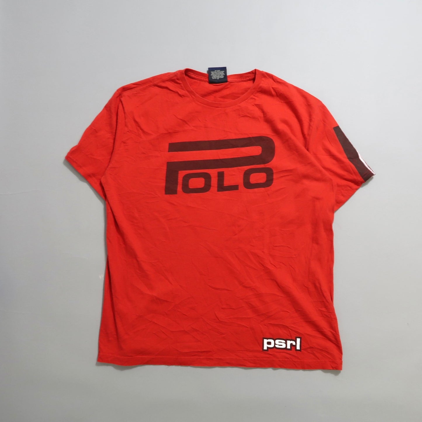 Red T-shirt with bold “Polo” logo and “psrl” text on sleeve.