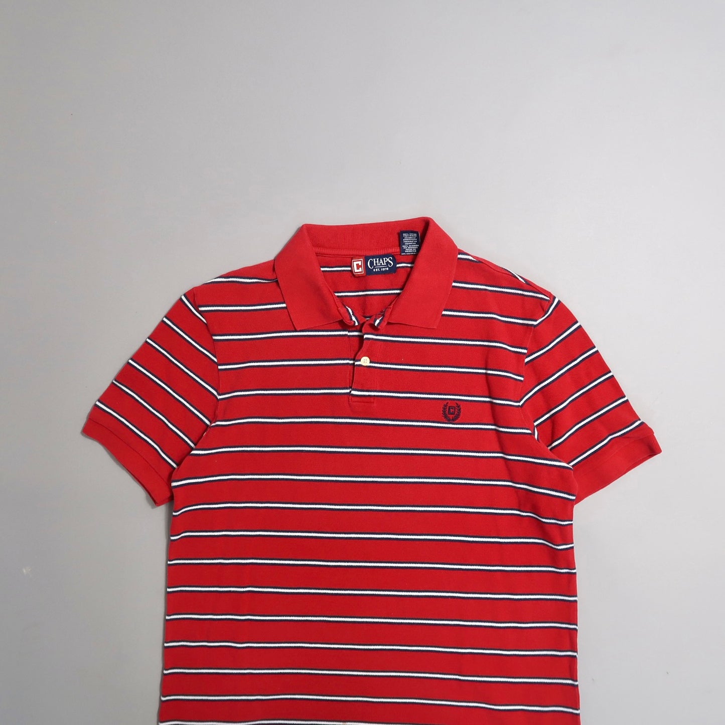 Red and white striped polo shirt on a plain background.