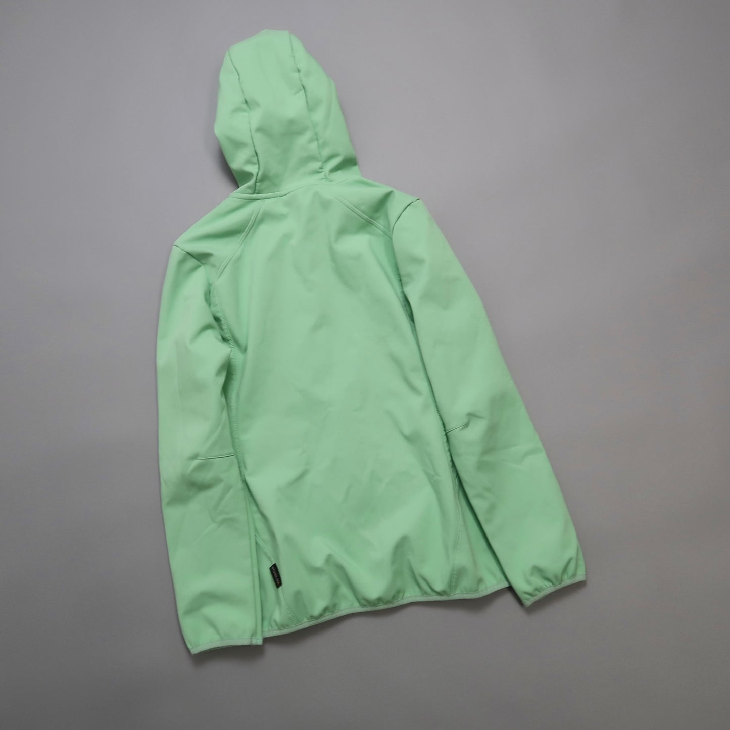 Mint green hooded jacket on a grey background.