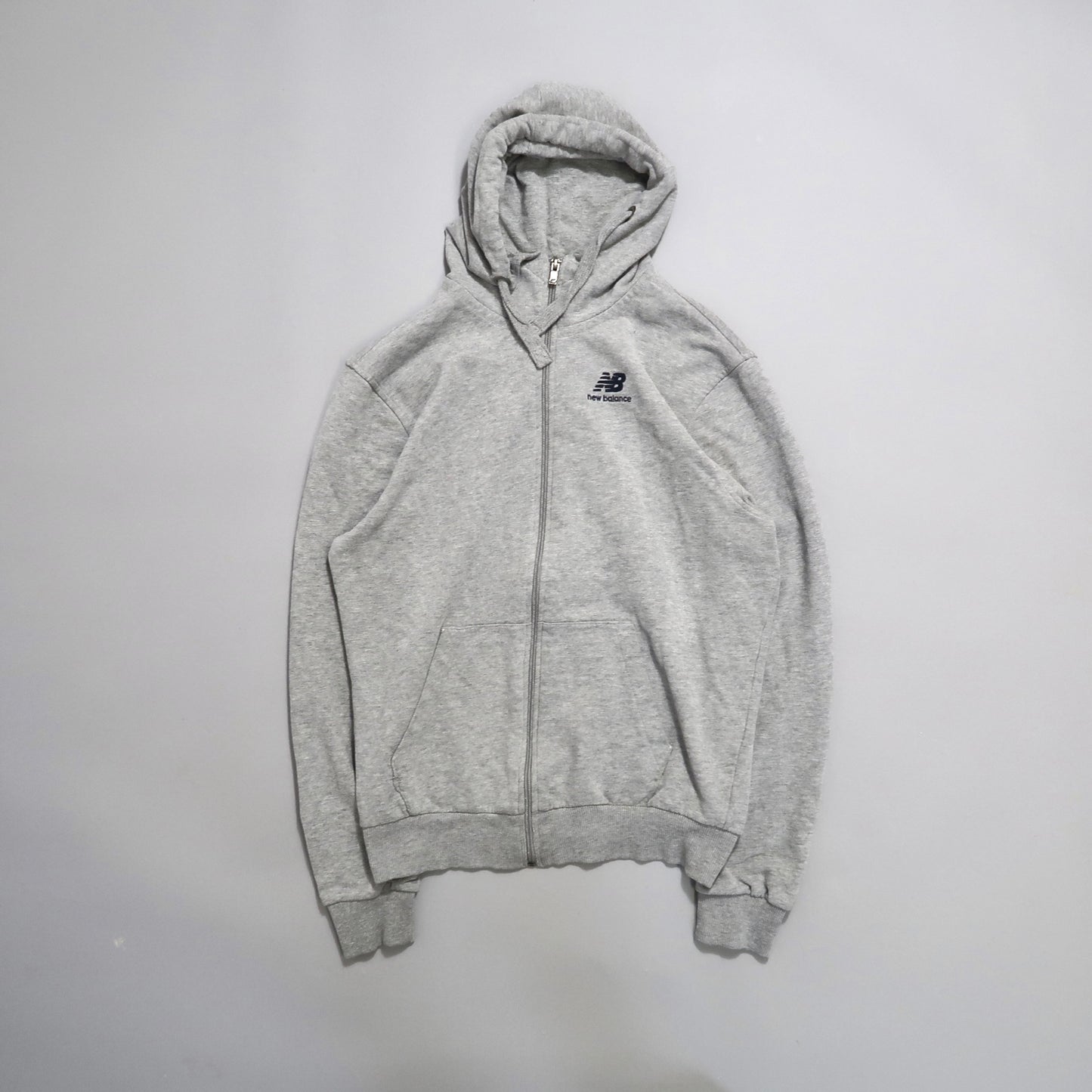 Gray zip-up hoodie with a small logo on the chest.