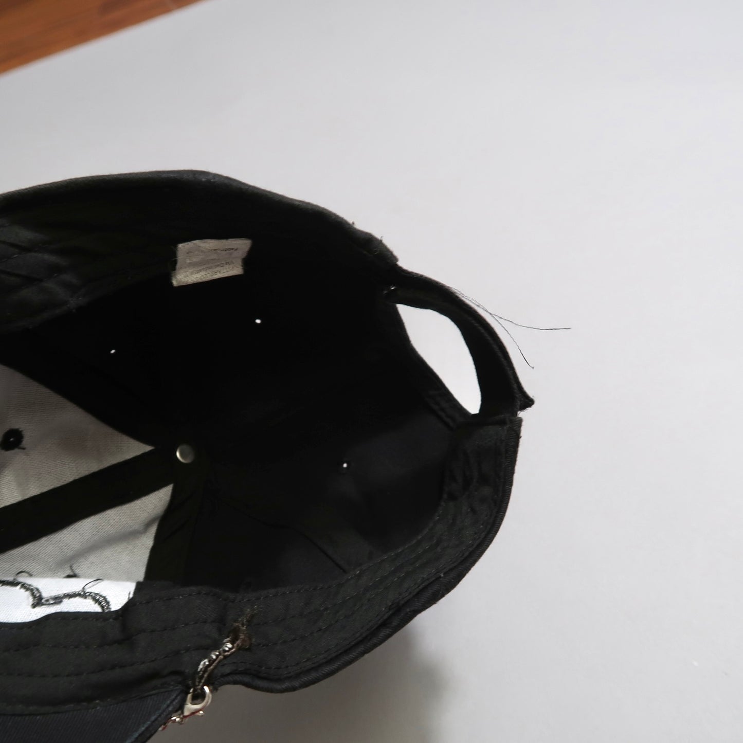 Inside view of a black cap on a light background.