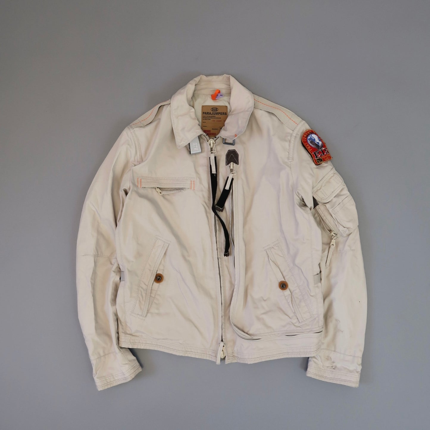 White Parajumpers jacket with patches and multiple pockets.