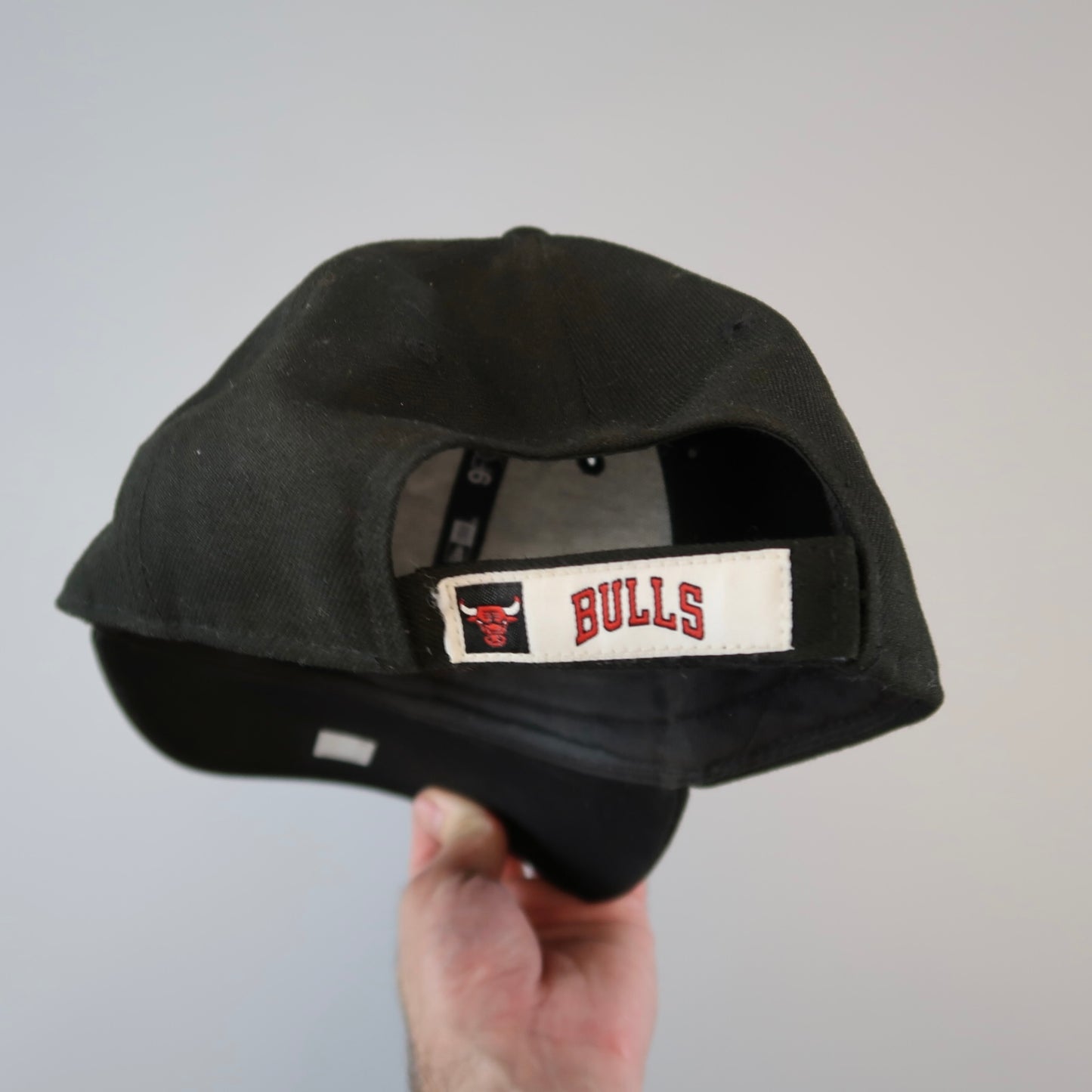 Black cap with nullBULLSnull and a bull logo on the back strap.