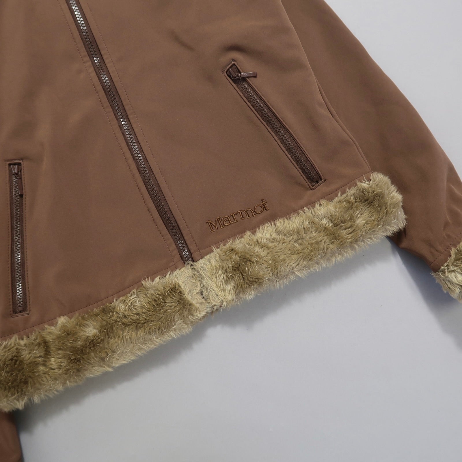 Brown jacket with fur trim and zippered pockets.