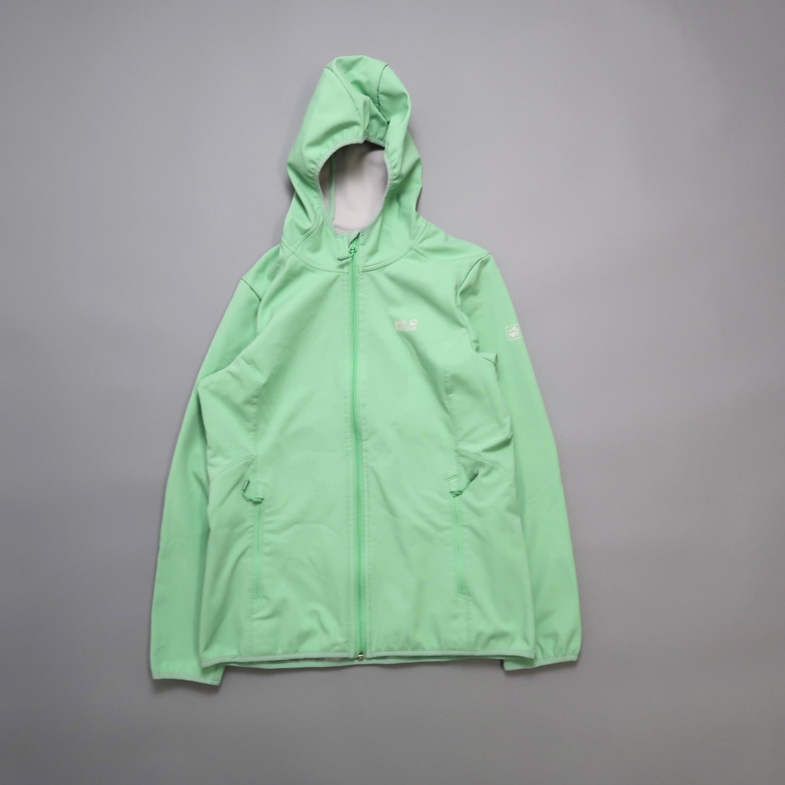 Green hooded jacket on a gray background.