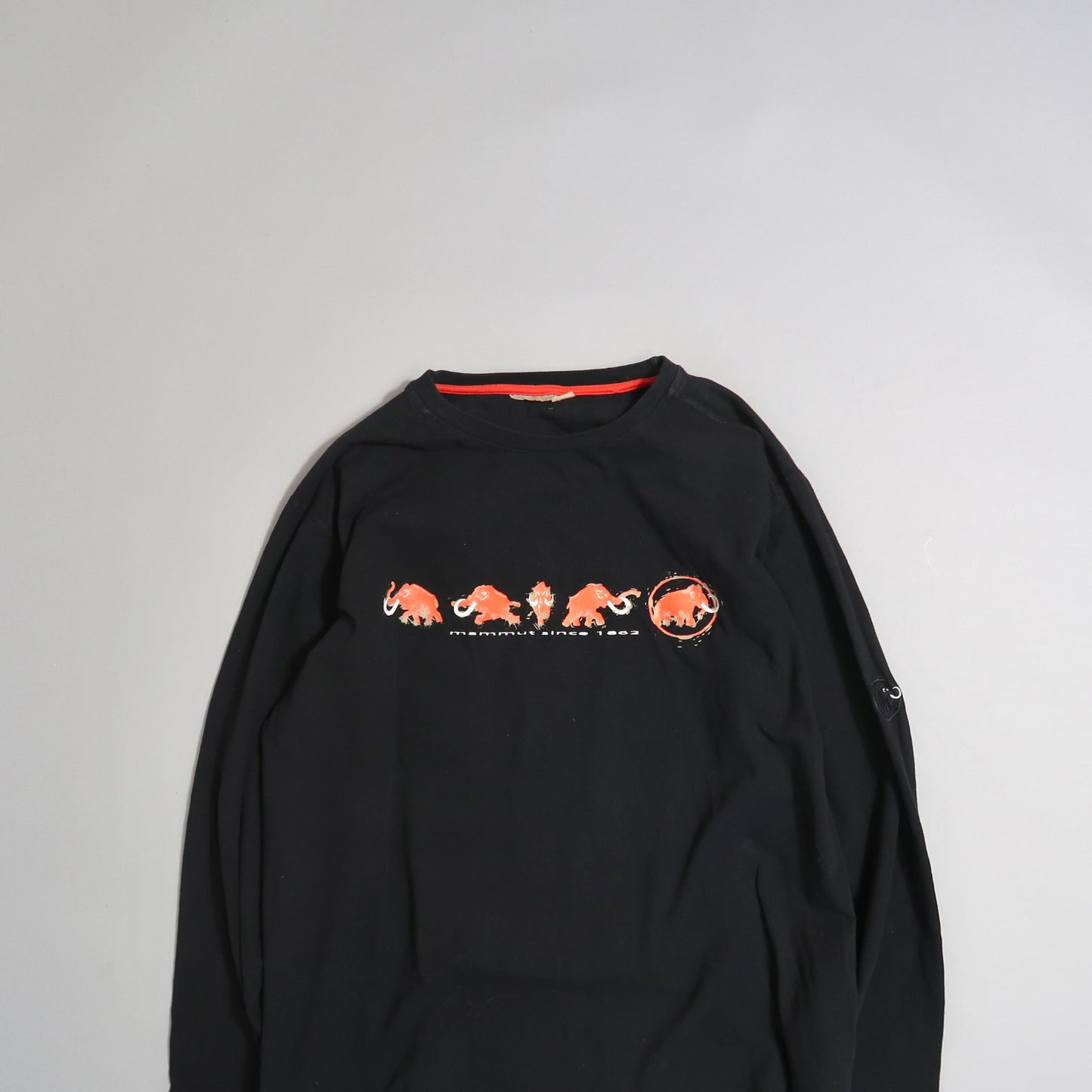 Black long-sleeve shirt with red mammoth design on chest.