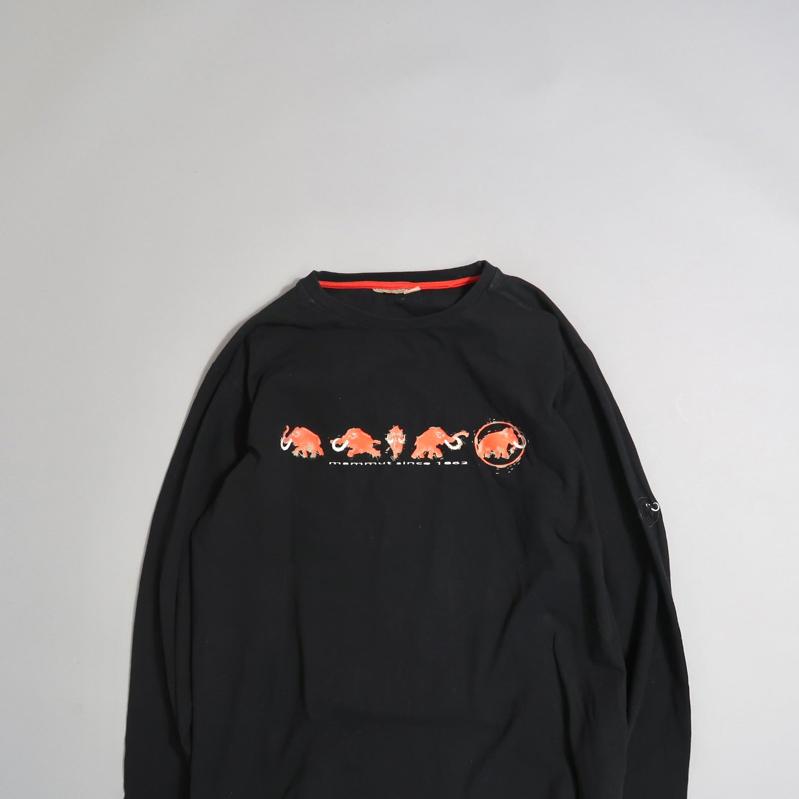 Black long-sleeve shirt with red mammoth design on chest.