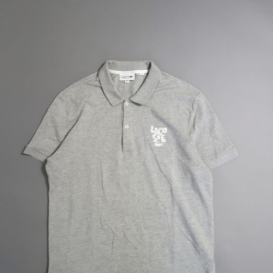 Gray Lacoste polo shirt with white logo on the chest.
