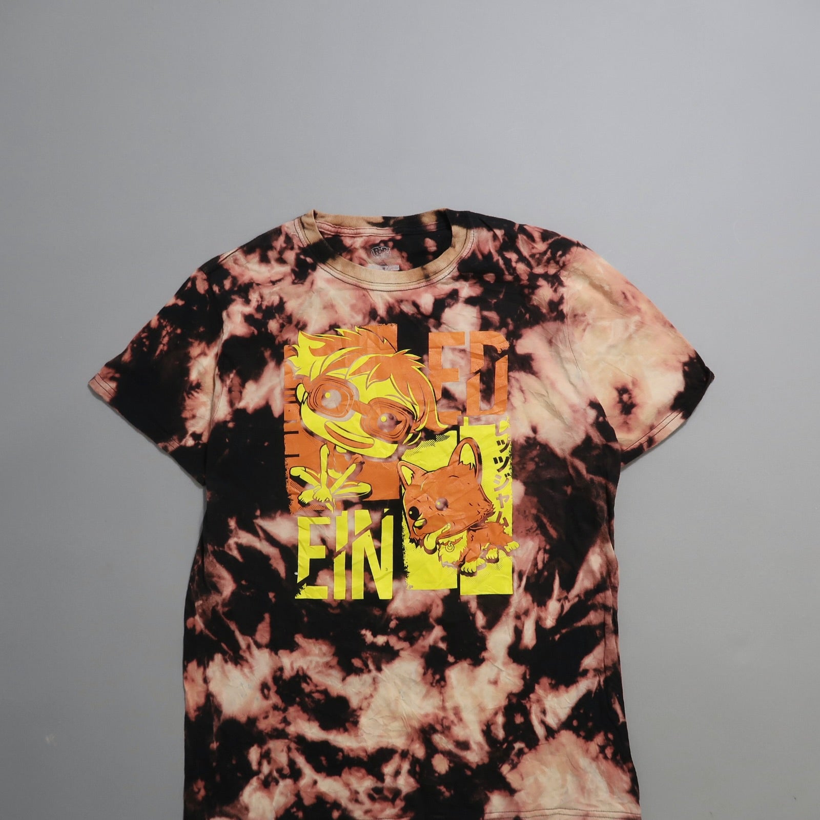 Tie-dye T-shirt with cartoon characters and Japanese text design.