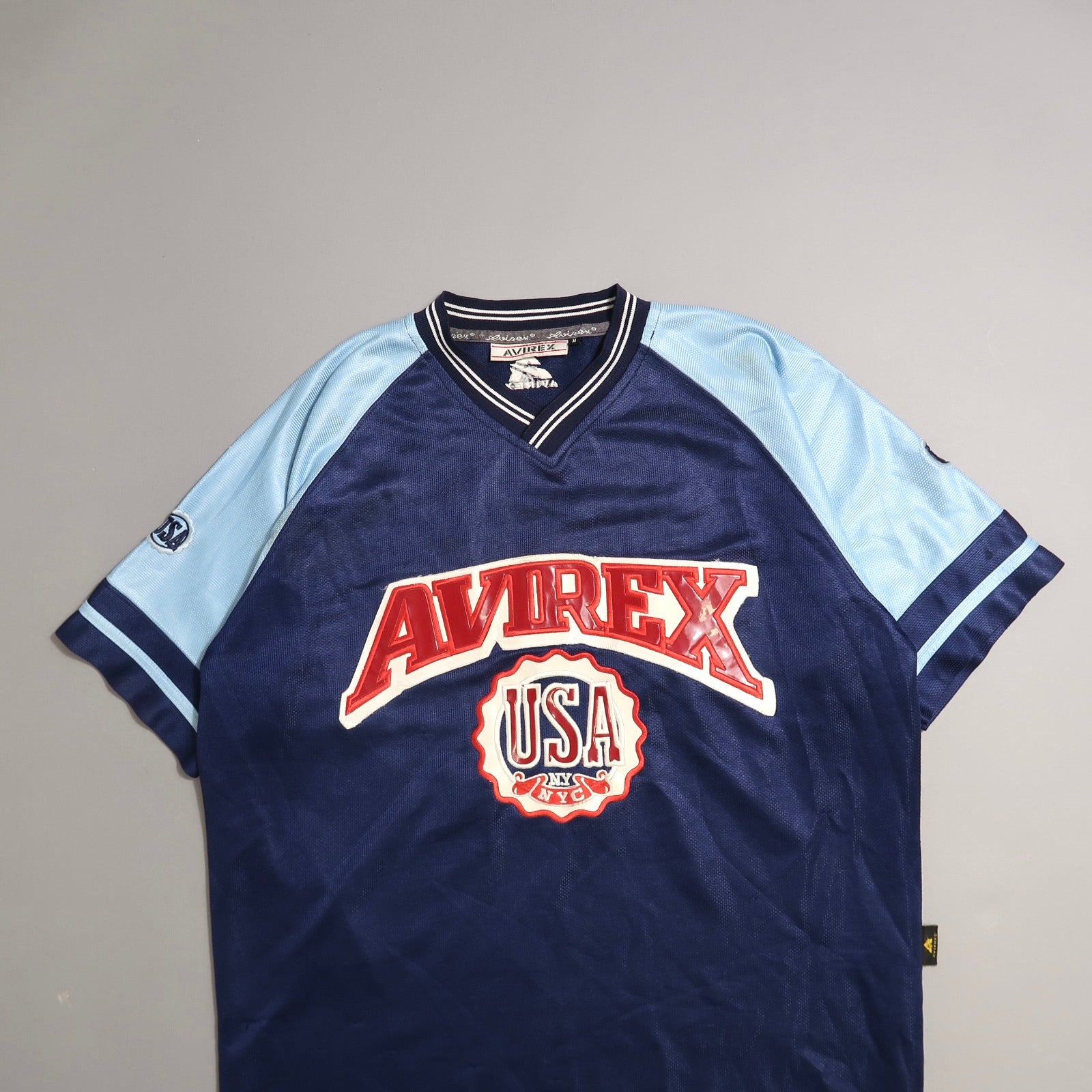 Navy and light blue Avirex jersey with USA NYC logo.