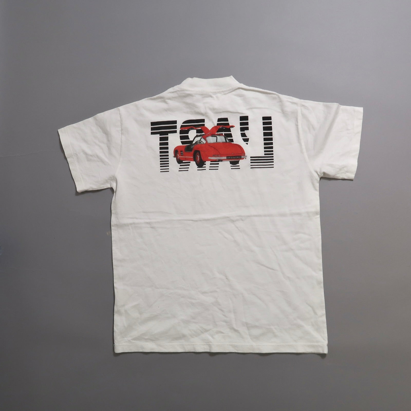 White T-shirt with red sports car graphic and text on the back.