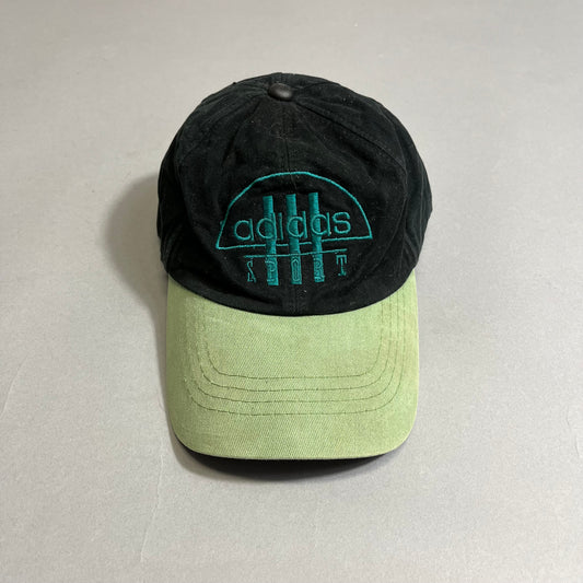Black and green Adidas Sport cap on a gray background.