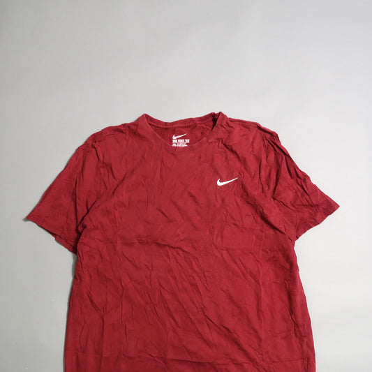 Red T-shirt with a white swoosh logo on a gray background.