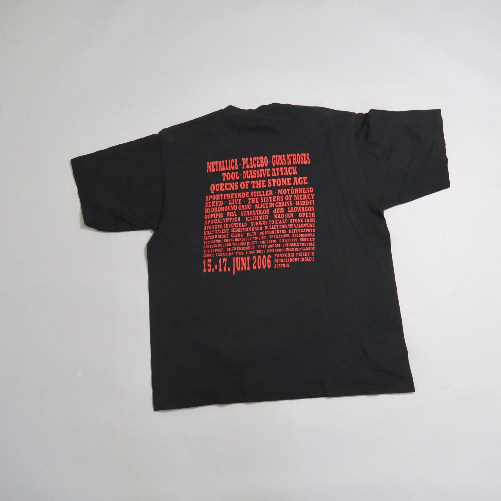 Black t-shirt with 2006 music festival lineup printed in red.