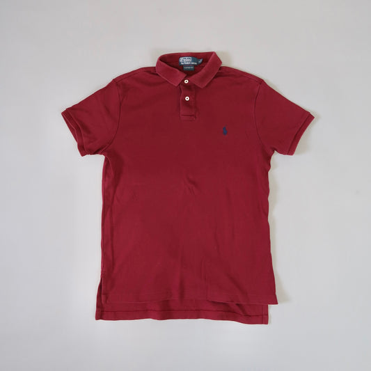 Red polo shirt on a plain background.