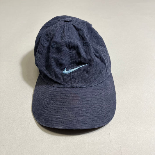Dark blue cap with a light blue Nike swoosh logo on the front.