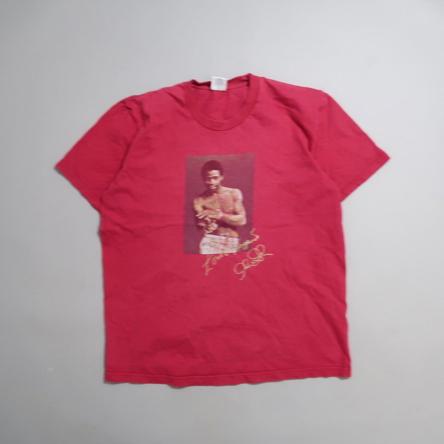 Red T-shirt with a boxer image and signature print.