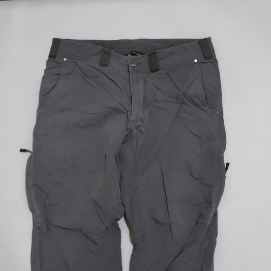 Gray cargo pants with multiple pockets laid flat.