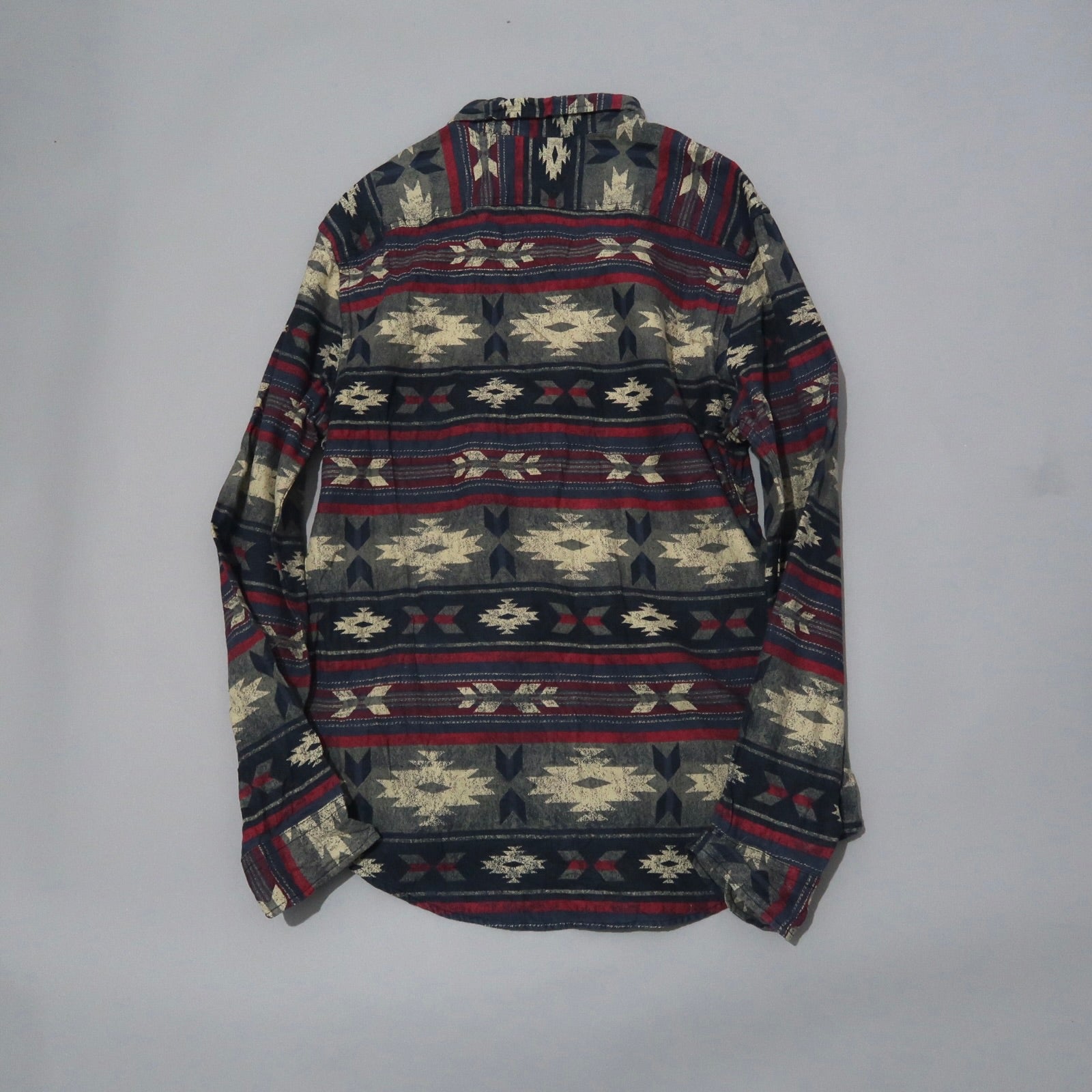 Patterned long-sleeve shirt with red, white, and blue geometric design.