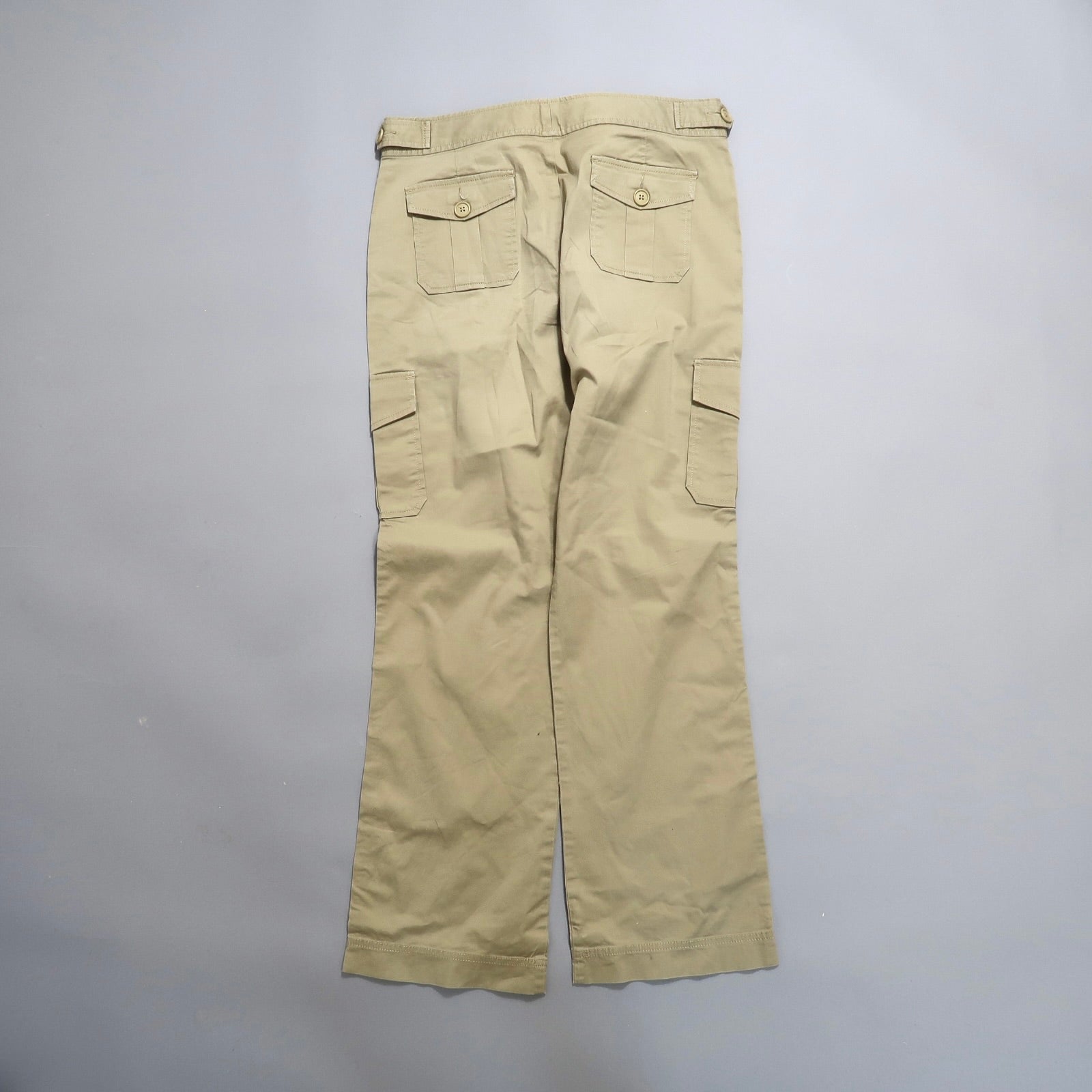 Khaki cargo pants with multiple pockets, viewed from the back.