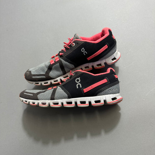 Gray and pink athletic shoes with distinctive white soles.