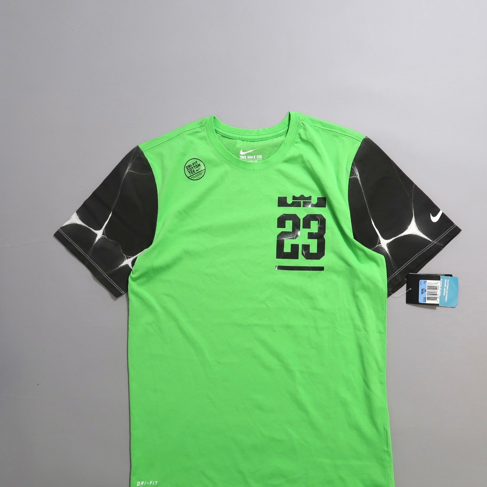 Green Nike Dri-Fit shirt with black sleeves and number 23 design.