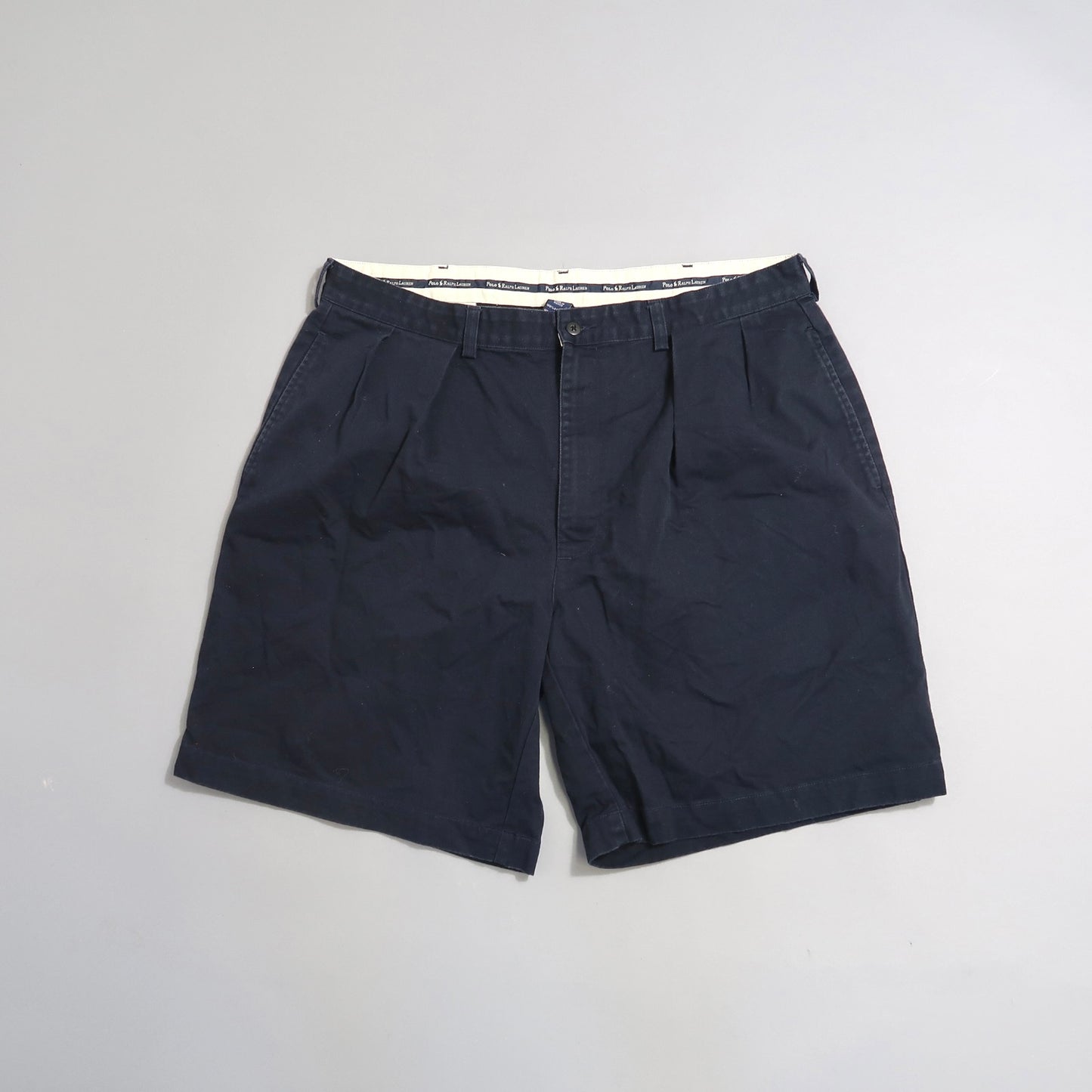 Dark blue shorts on a light gray background.