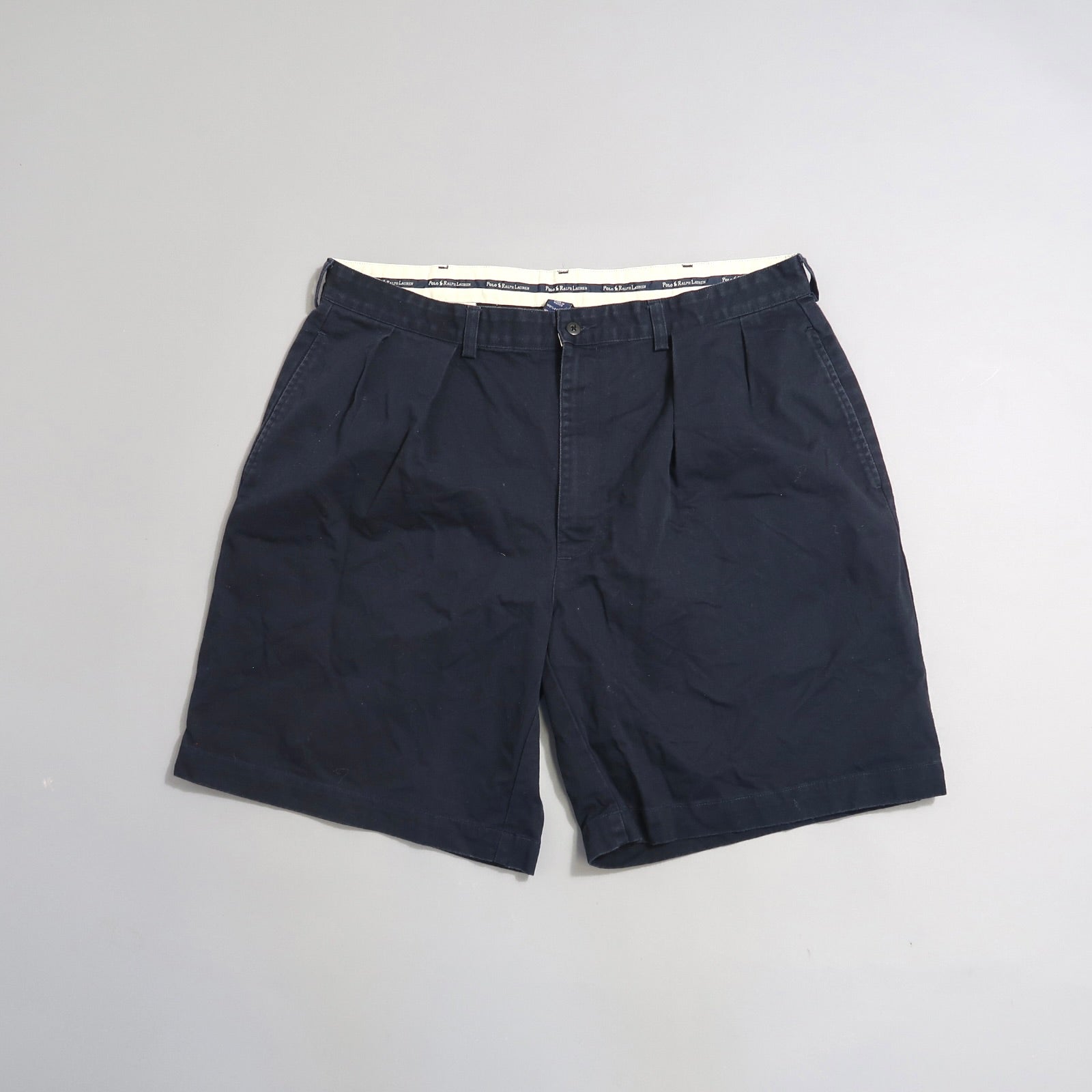 Dark blue shorts on a light gray background.