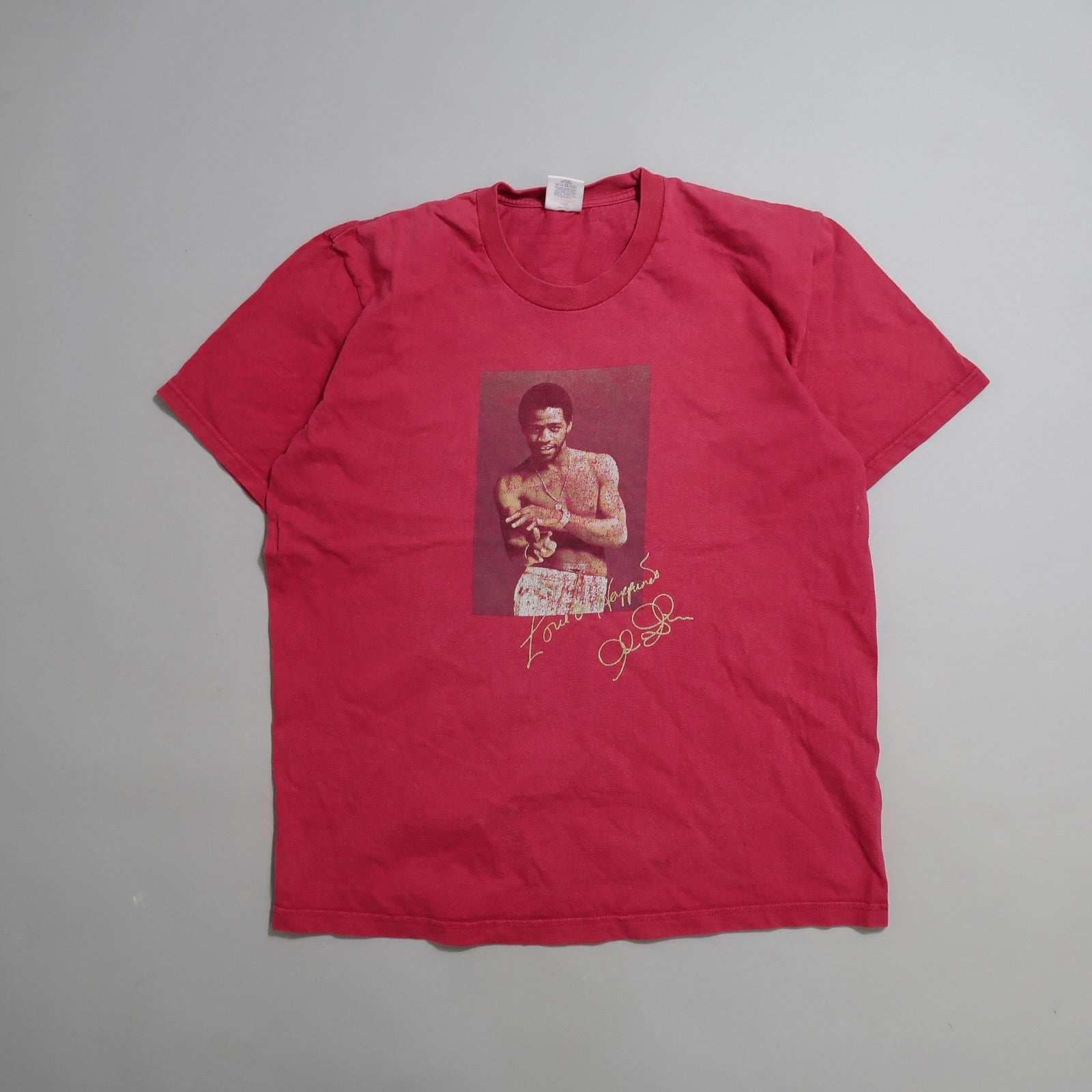 Red T-shirt with a photo of a person holding a kitten, text below.