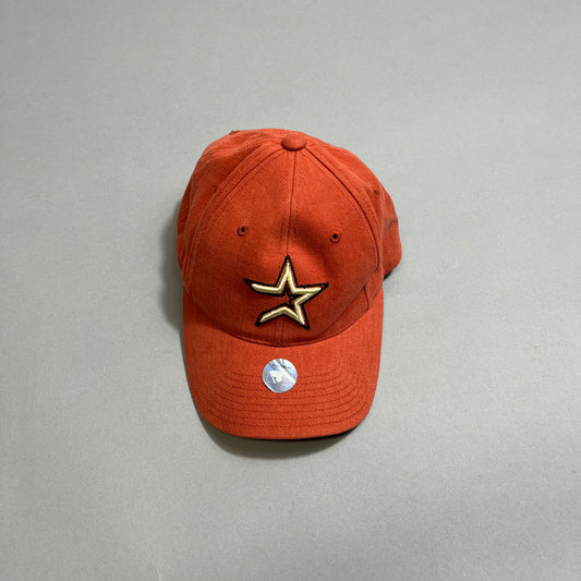 Rust-colored cap with gold star logo and sticker on the brim.