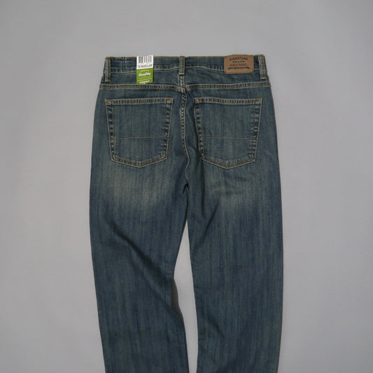Back view of blue denim jeans with two pockets and brand label.