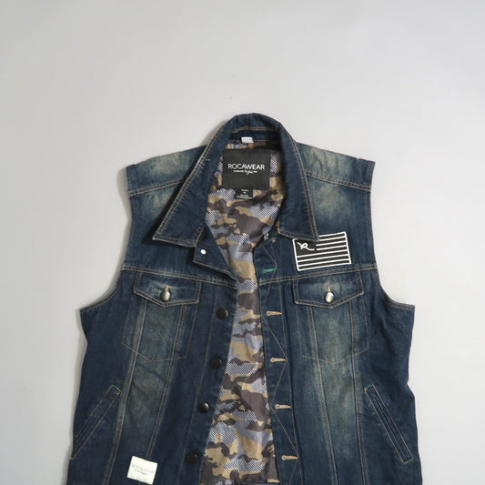 Denim vest with camo lining and patch detail on the front.
