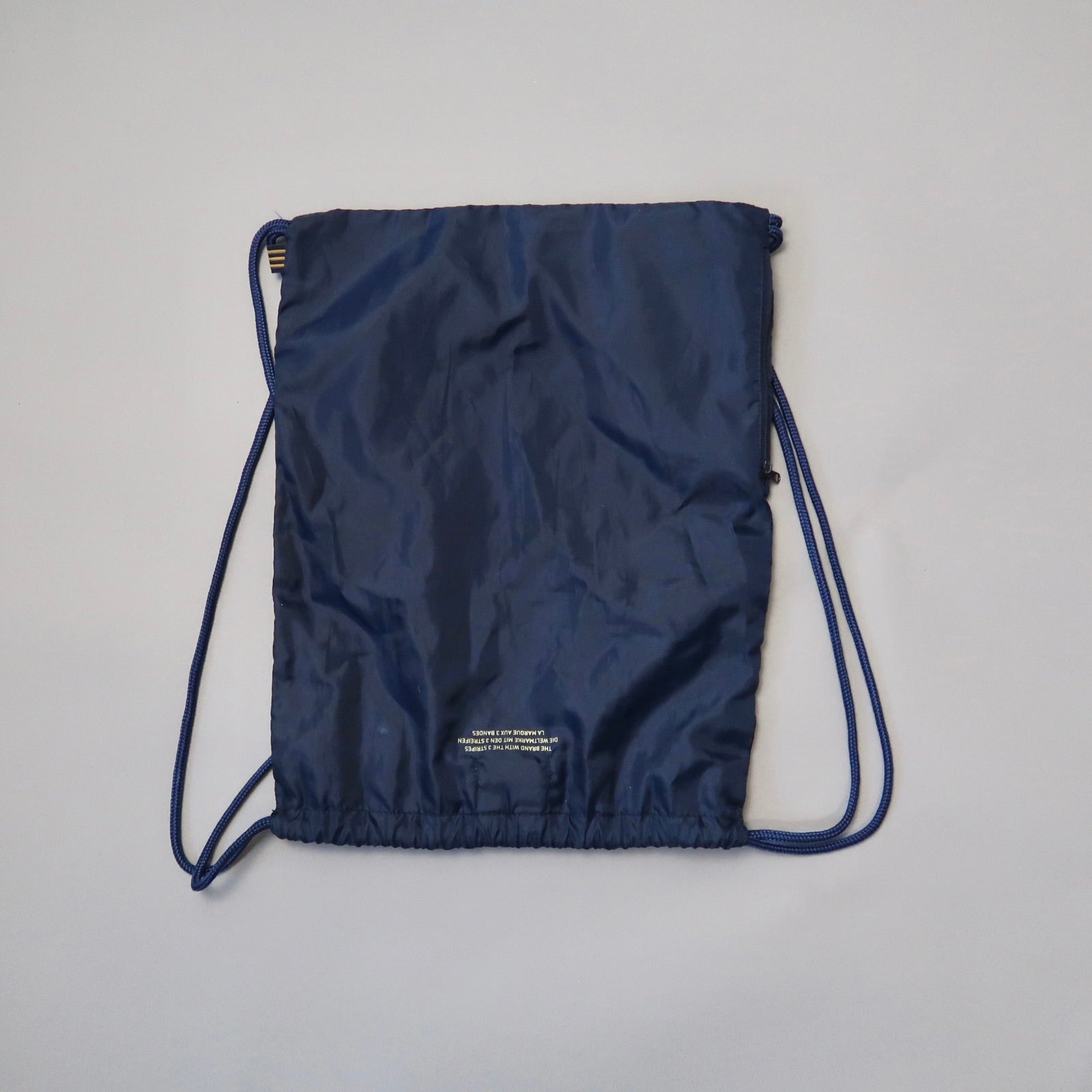 Blue drawstring backpack on a neutral background.