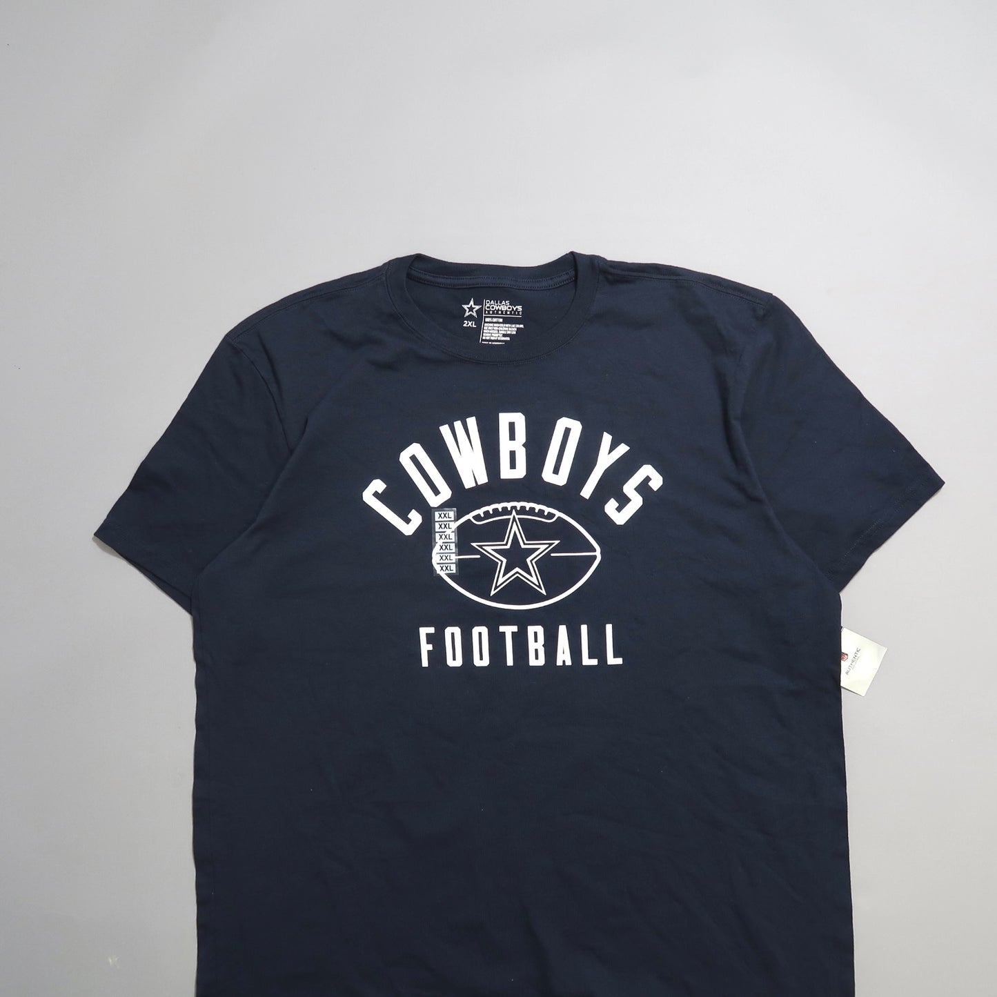 Navy blue Cowboys Football T-shirt with star logo and size tag.