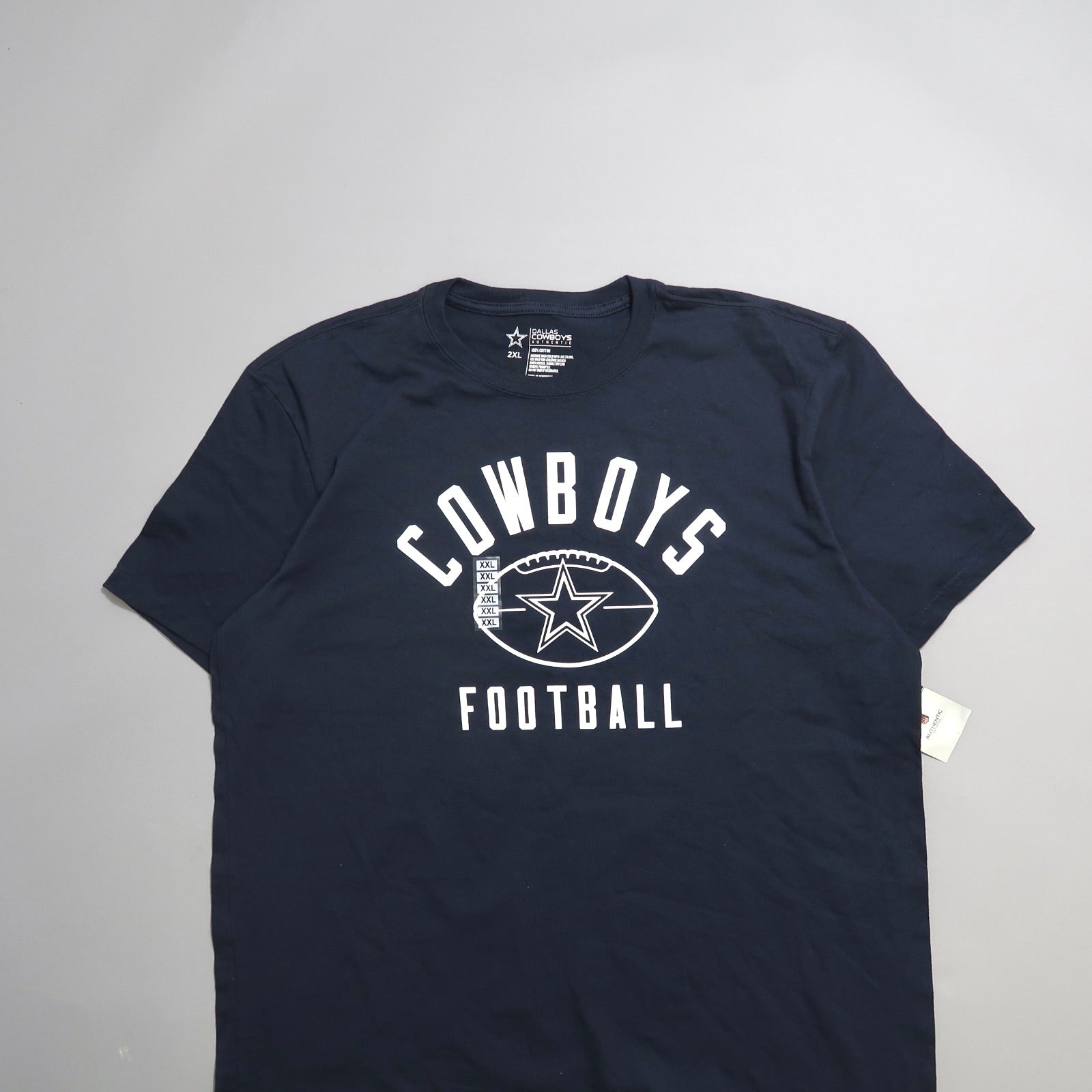 Navy blue Cowboys Football T-shirt with star logo and size tag.