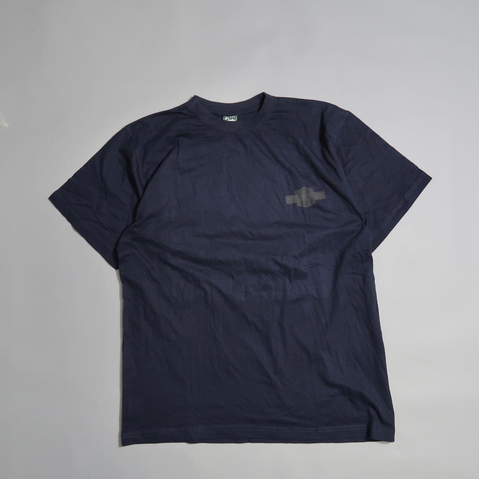 Dark blue T-shirt with subtle chest logo on light gray background.