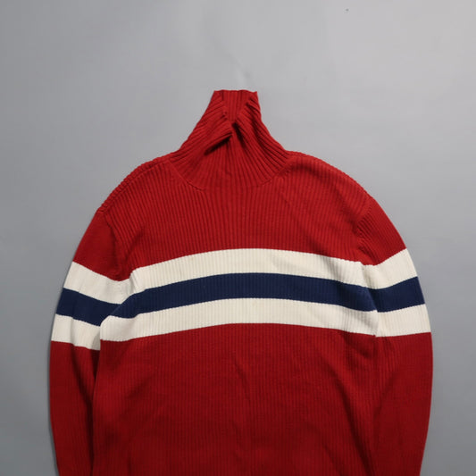 Red sweater with white and navy horizontal stripes.