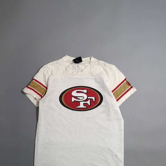 White sports jersey with nullSFnull logo and red-gold stripes on sleeves.